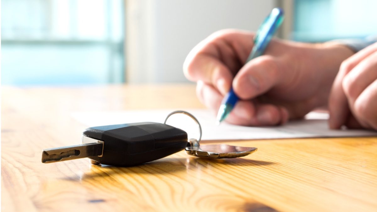 Person signing contract for car